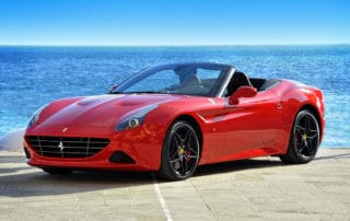 red Ferrari California T Handling Speciale on the waterfront of the Mediterranean Sea