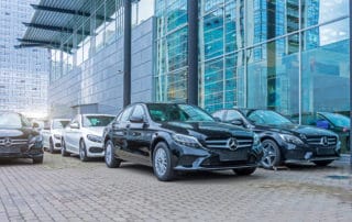 Luxury cars Mercedes-Benz C and E class parking in front of car store. Russia. Saint-Petersburg.