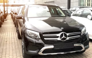 Luxury cars Mercedes-Benz C and E class parking in front of car store