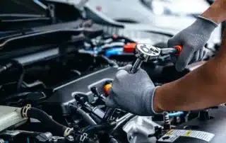 Land Rover SUV being serviced by a certified auto mechanic, inspecting for oil leaks and performing engine tune-up and filter replacement