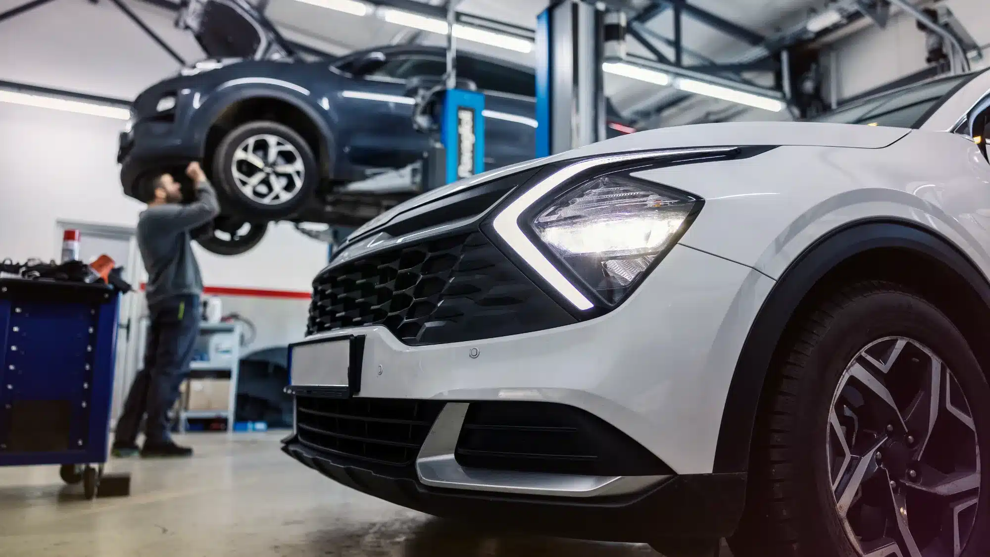 foreign auto mechanic inspecting a european vehicle at a mercedes benz service center